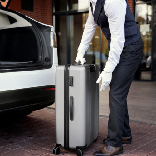 side-view-valet-holding-baggage